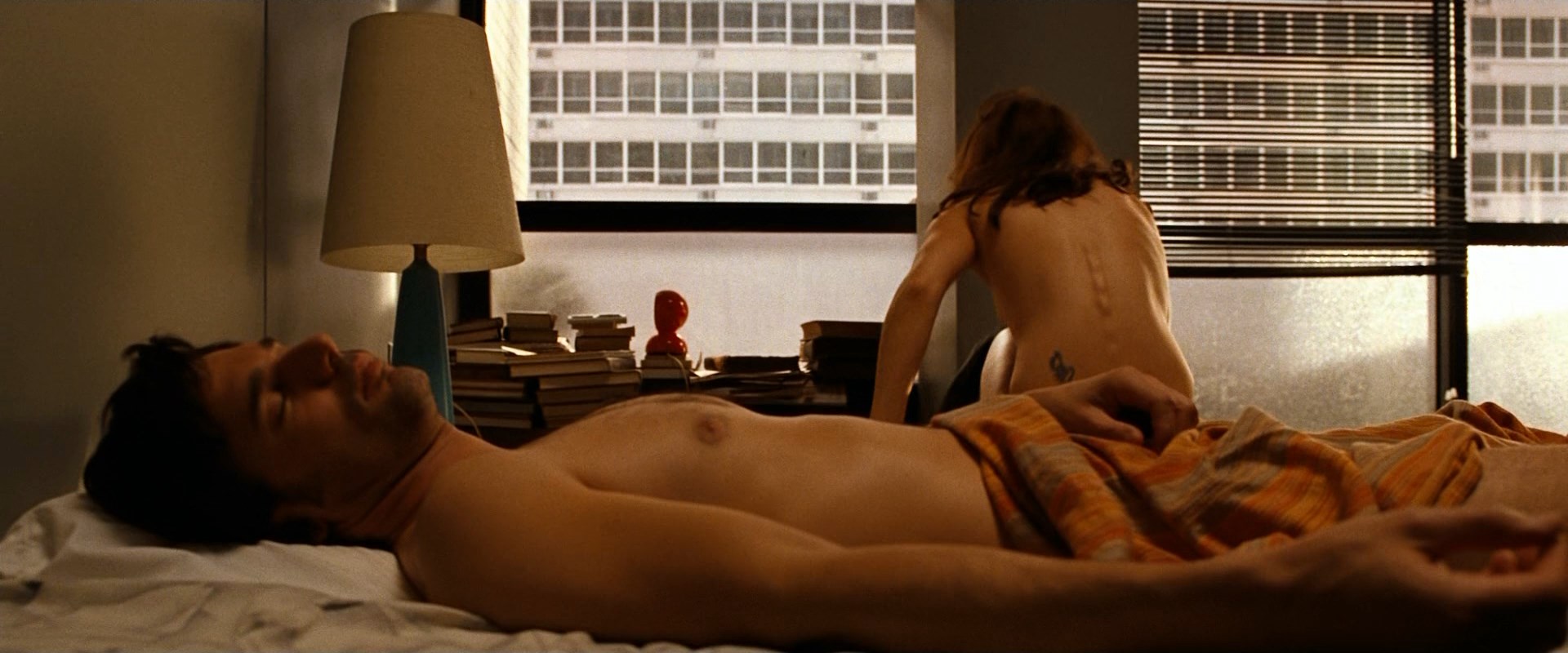 Naked Rachel McAdams gets up from the bed and puts an shirt on. 
