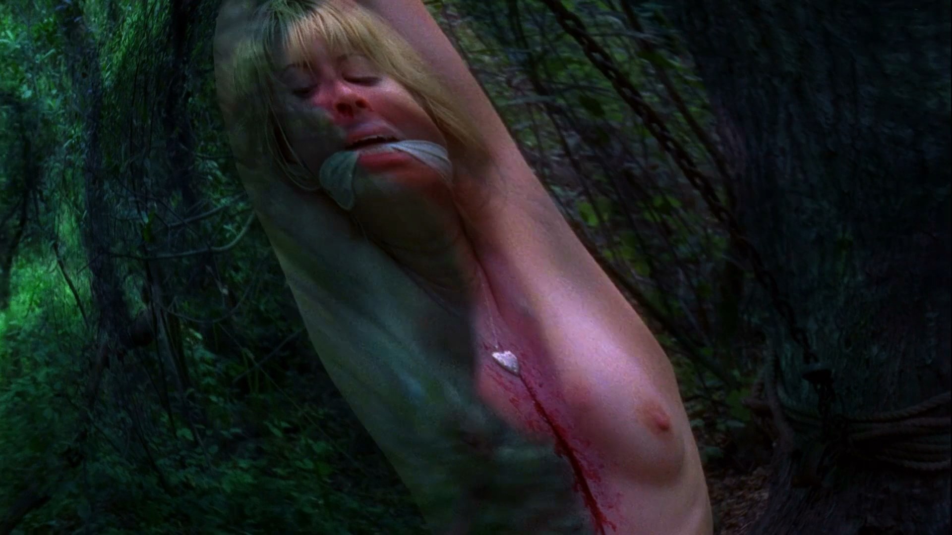 Quick weirdly edited scene where Tara is hanging out from the tree topless.