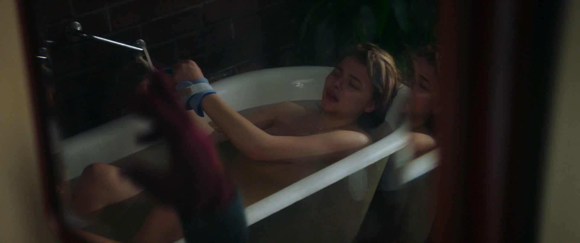 Chloe Grace Moretz is bound in the tub. 