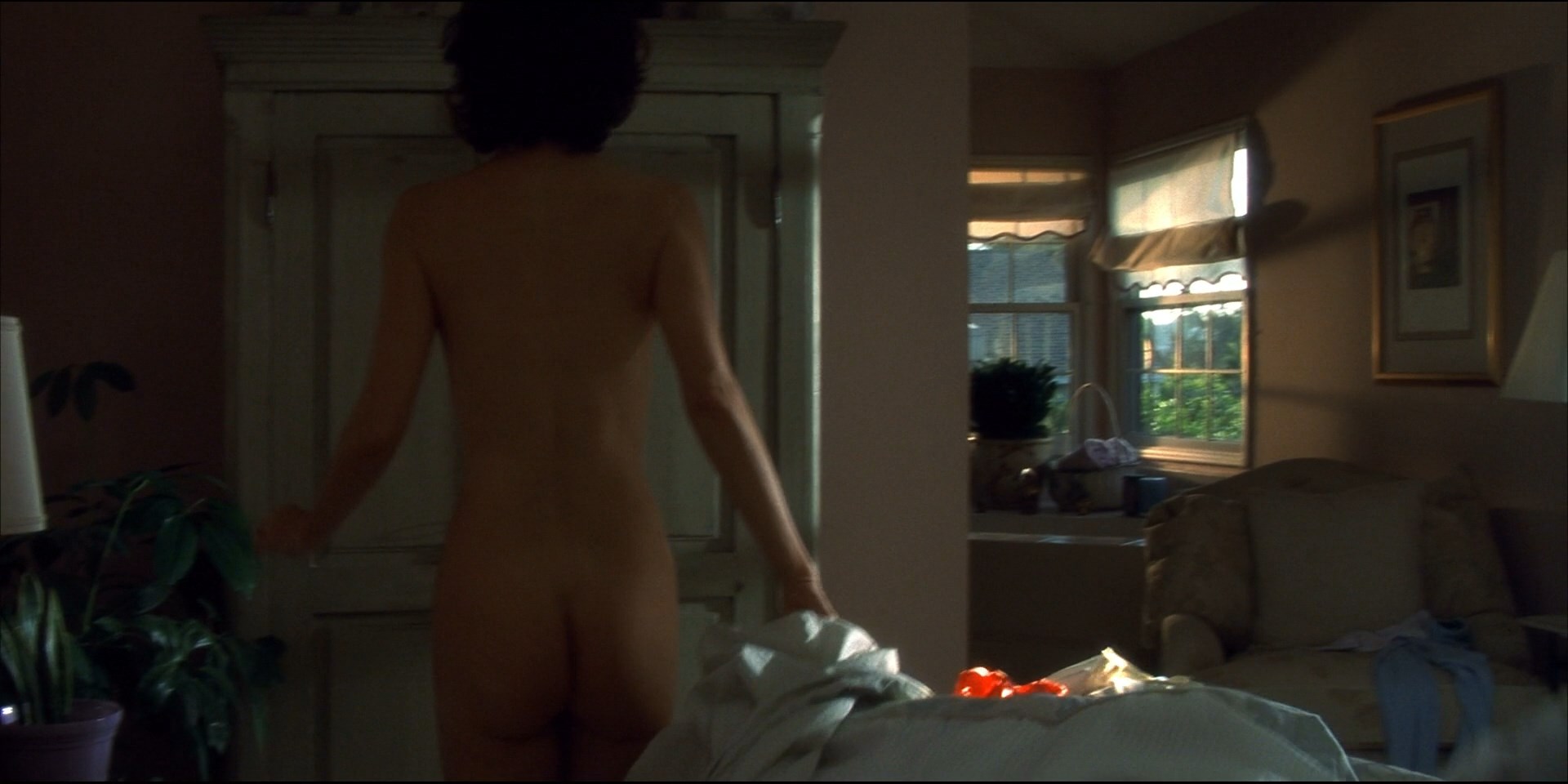 Mary Steenburgen gets up from the bed showing her ass and briefly her tits.