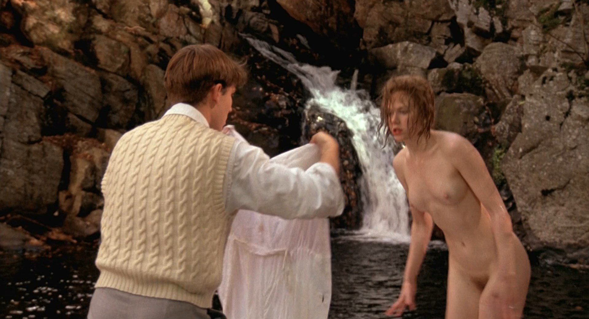 Fully naked Nicole Kidman walks from the water and puts a shirt on.