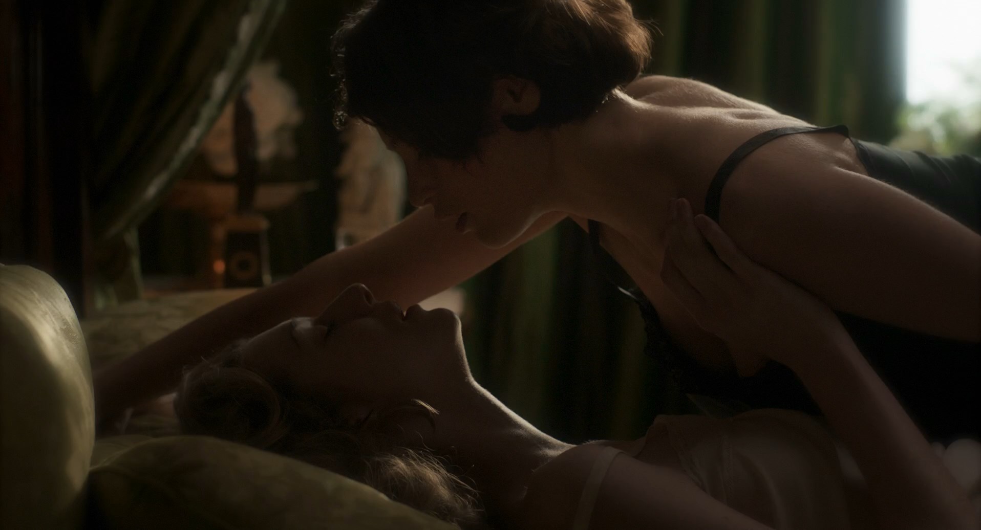 Gemma Arterton and Elizabeth Debicki starts kissing. 