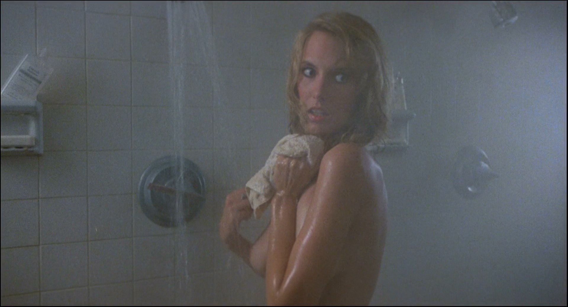 Topless Leslie Scarborough is taking a shower when so guy suprises her.
