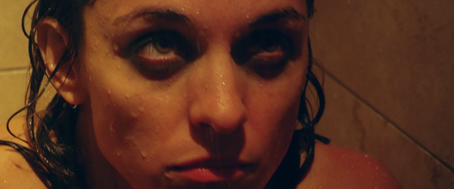 Youlika Skafida is in the shower topless and bloodied.
