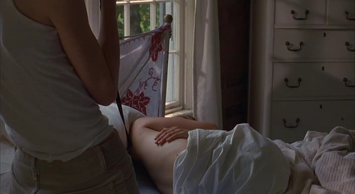 Radha Mitchell is laying naked on the bed while Ally Sheedy takes photo’s o...