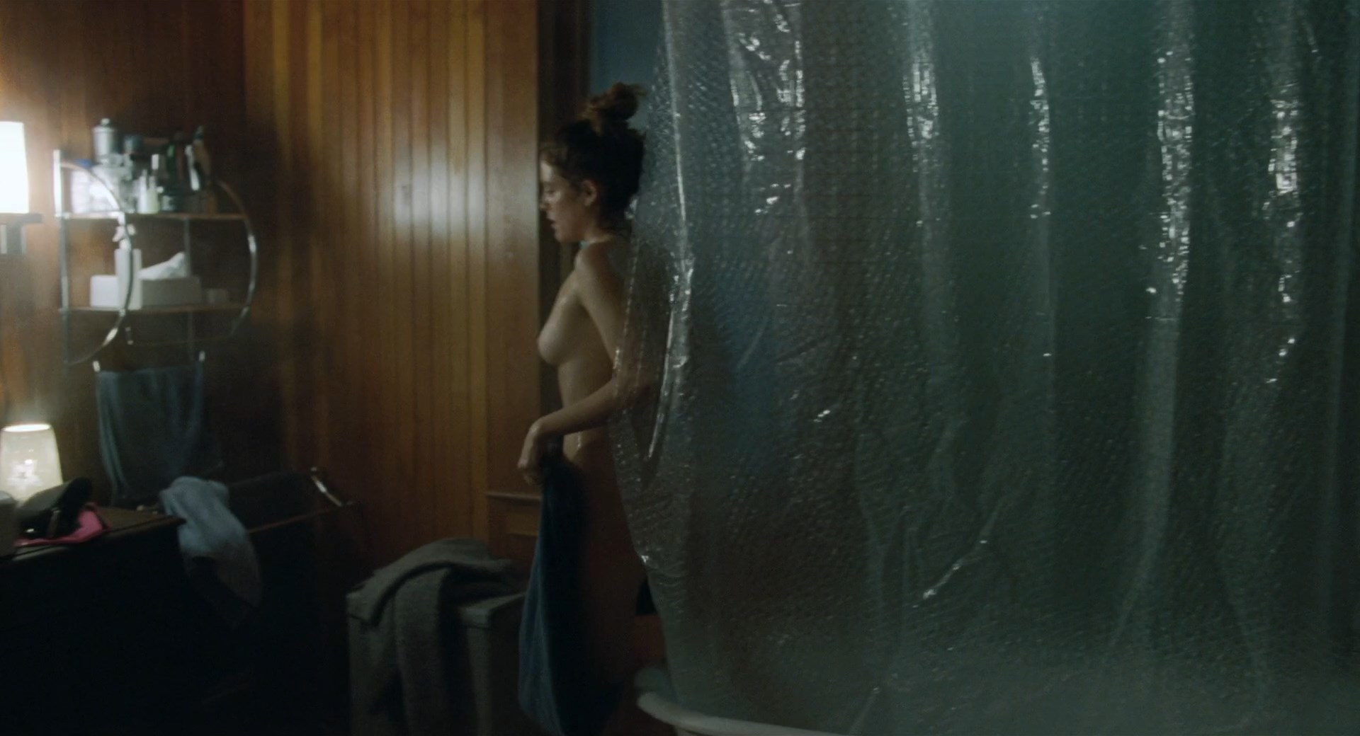 Riley Keough comes out from the shower, she shows her tits.