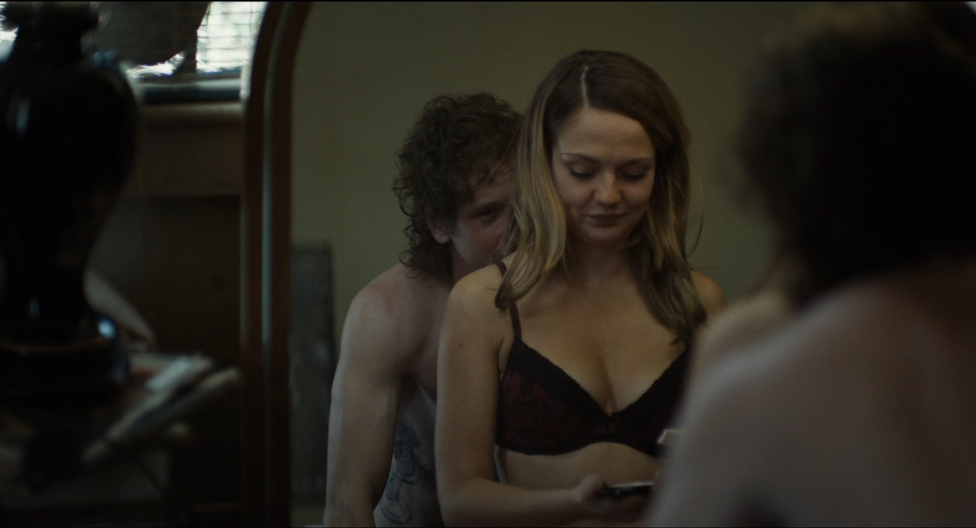 Emily Meade shows her tits while putting on a bra.