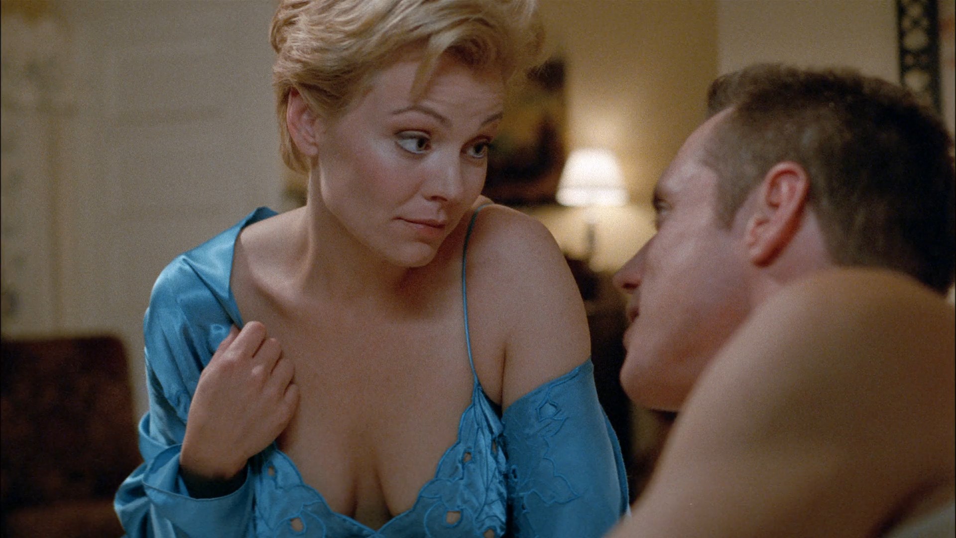 Gail O’Grady shows nice cleavage while talking to some guy.