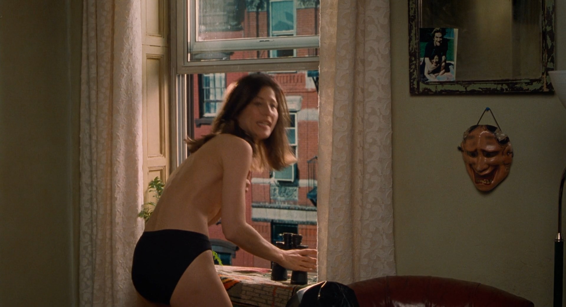 Catherine Keener shows her tit before she gets up from the bed and is cover...