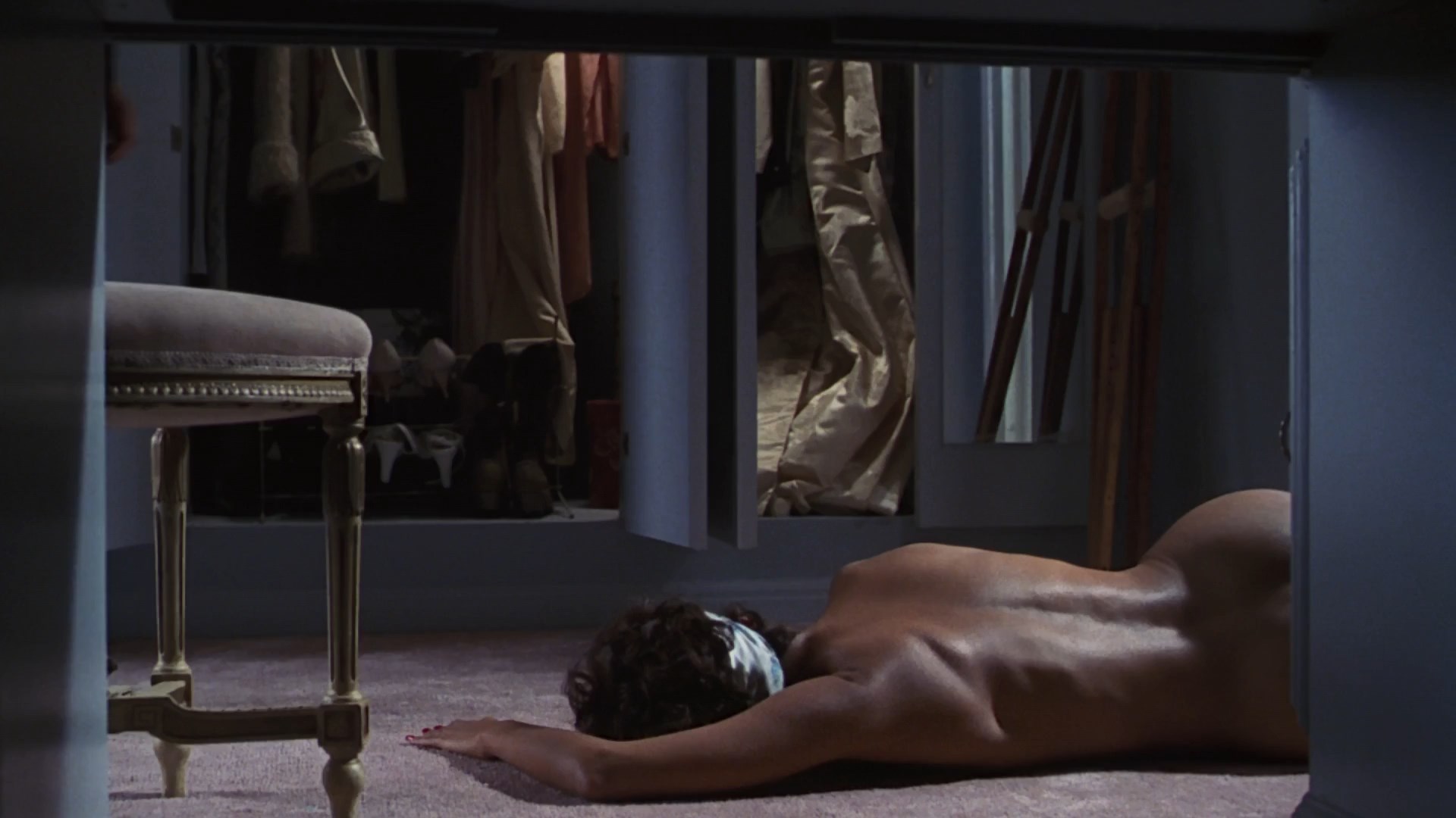 Halle Berry is laying on the floor naked and dead. 