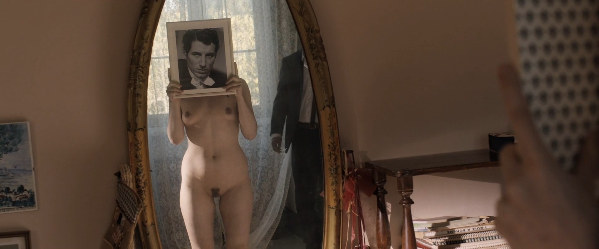 Fully naked Pihla Viitala watches herself from the mirror. 